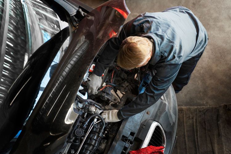 mechanic repairing a bmw car