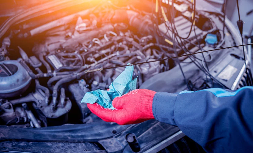 mechanic adding car power steering fluid