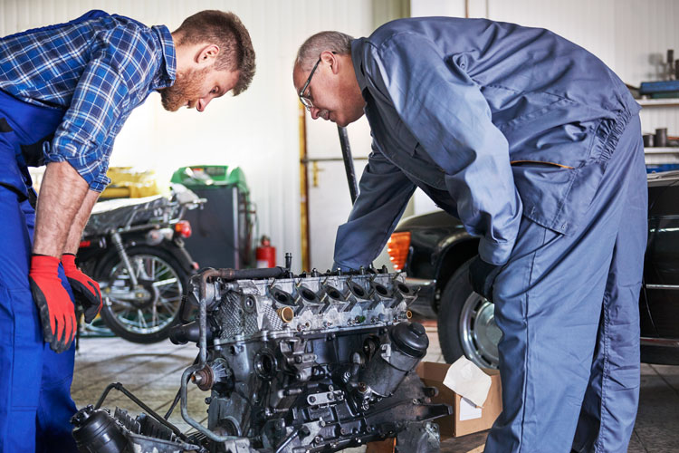 mechanics looking at BMW engine